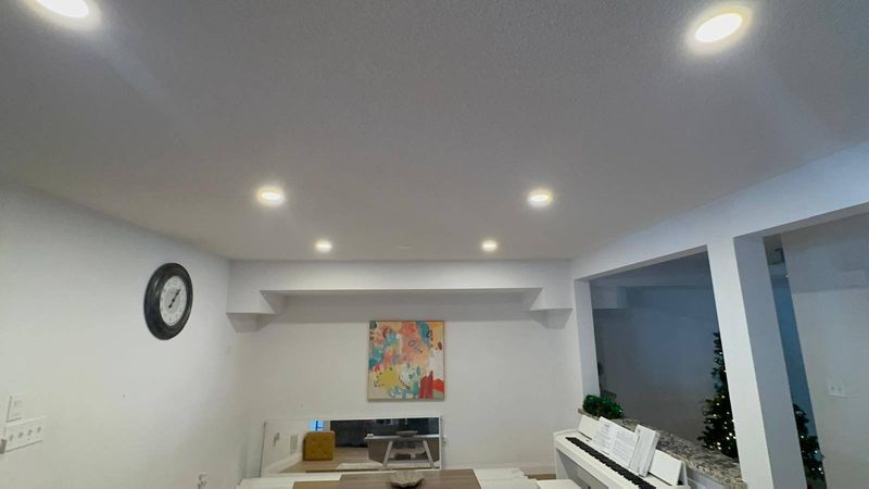 Master Electrician installing recessed pot lights