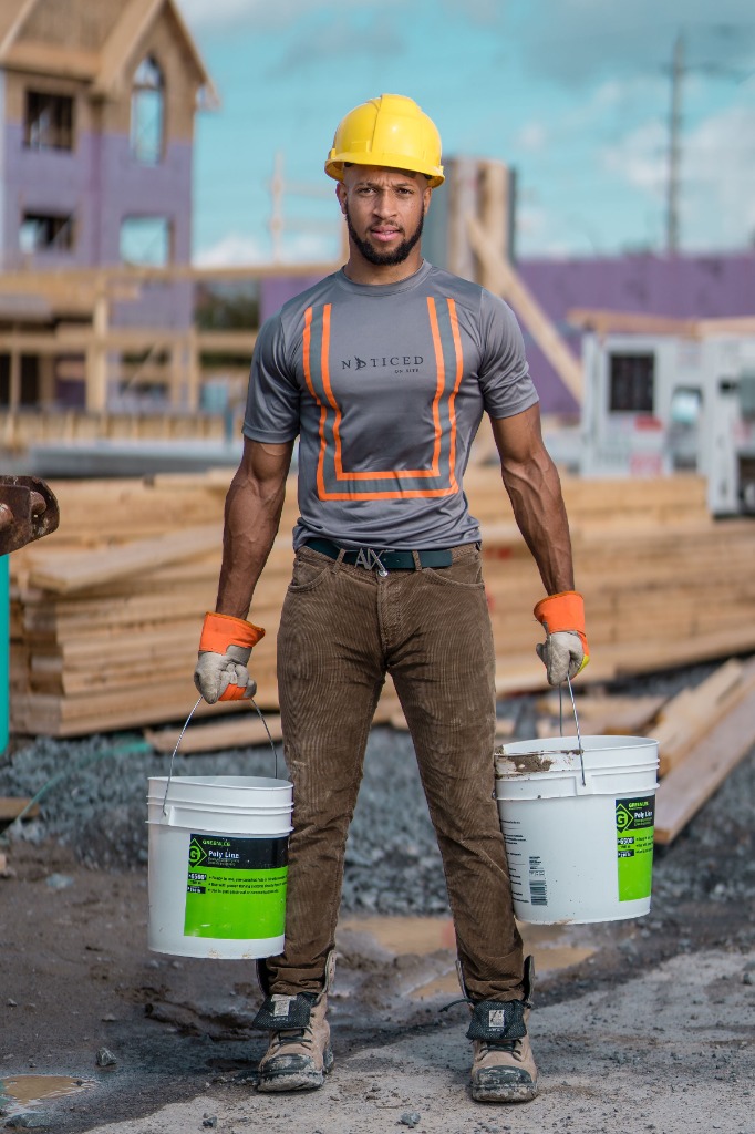 Electrician carrying a spool of wire